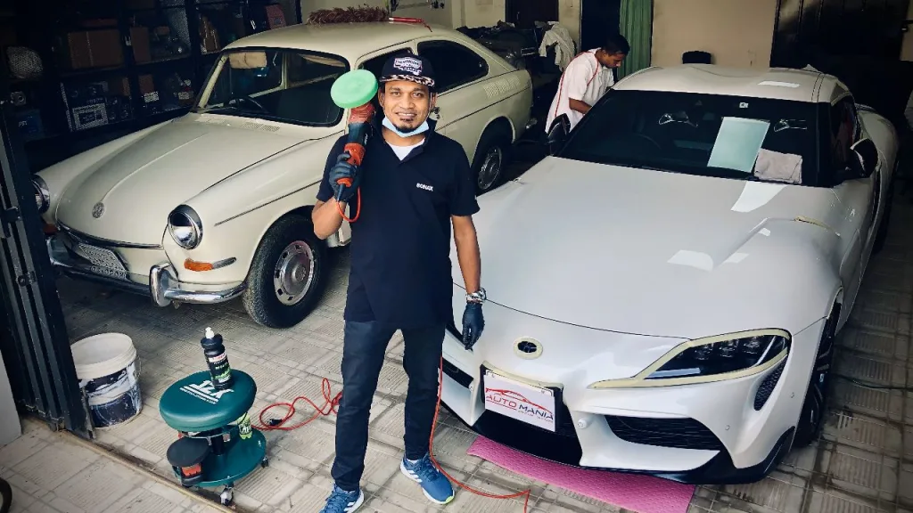 Master Detailer standing in front of white Supra. Booking Open.